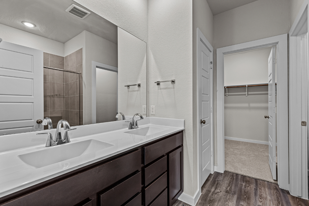 A bathroom with a large mirror.