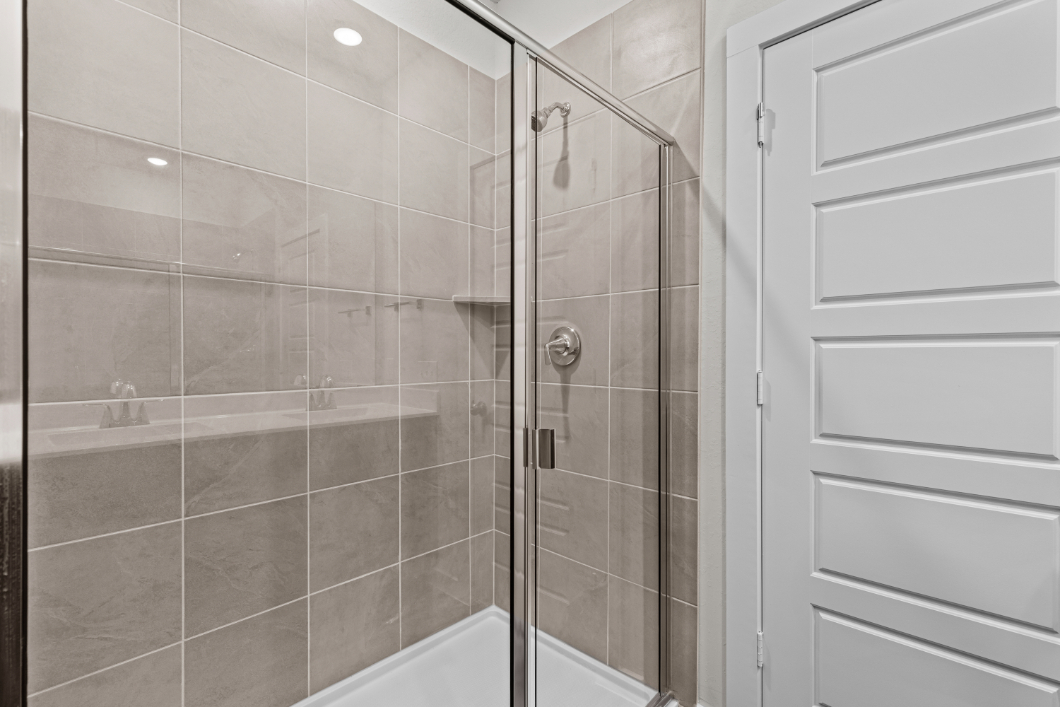 A shower with a glass door.