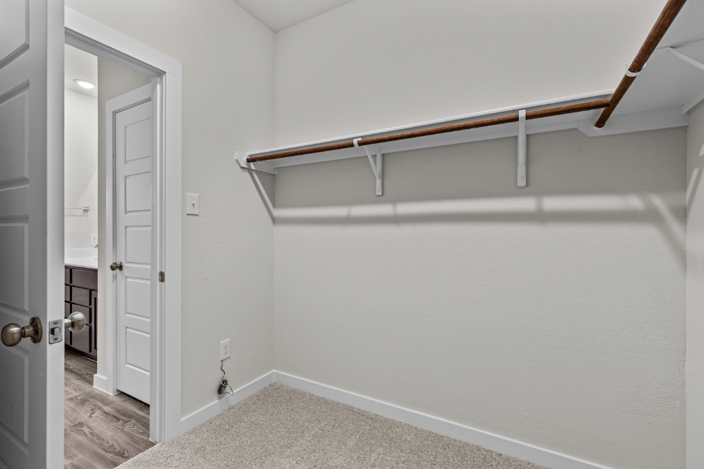 A white room with a metal bar.