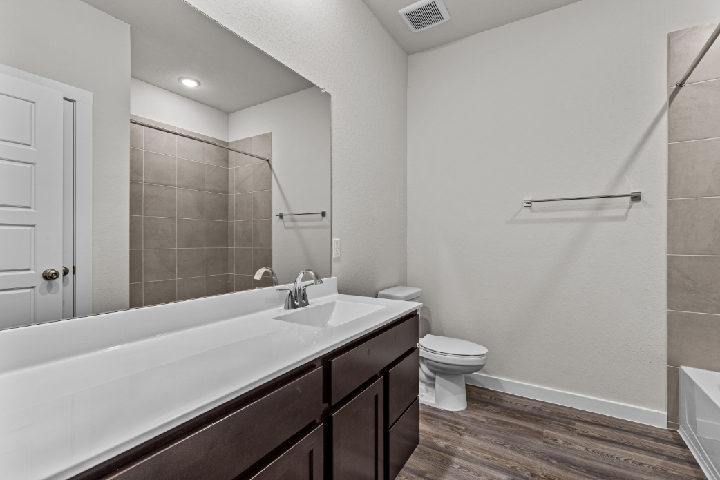A bathroom with a tub toilet and sink.