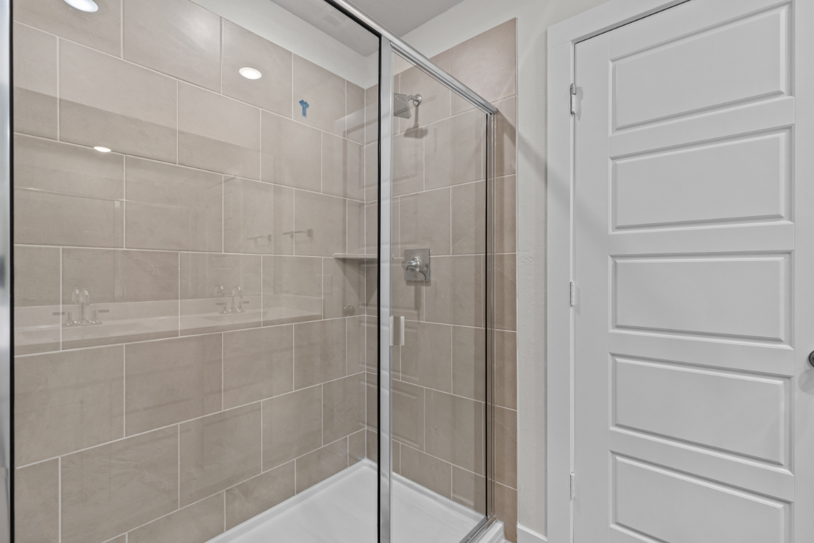 A shower with a glass door.