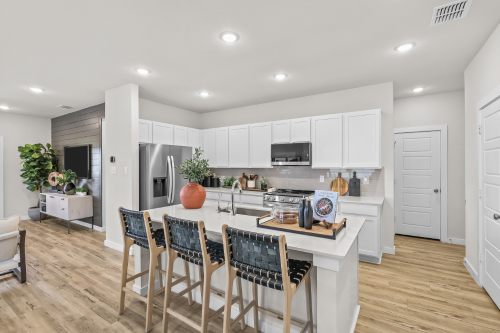 A kitchen with white cabinets.