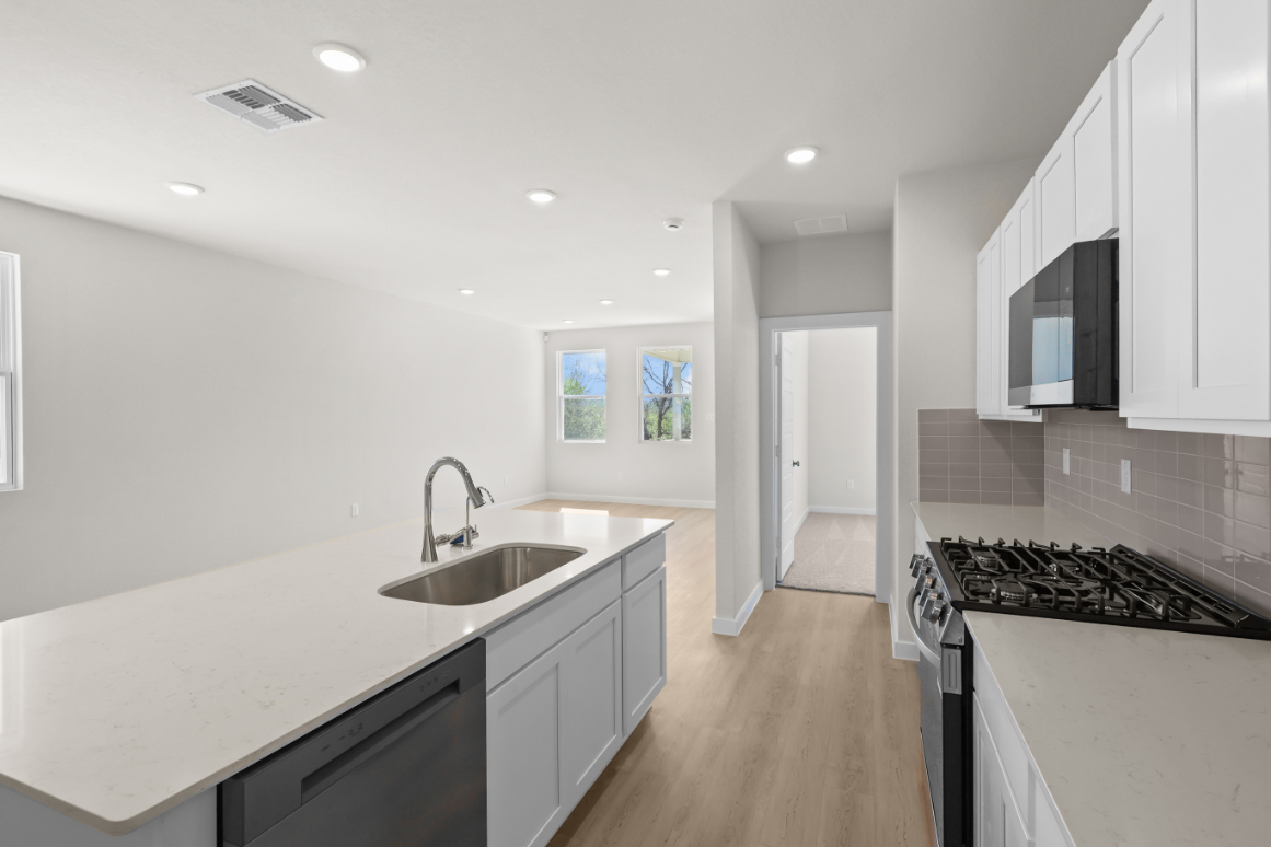 A kitchen with white cabinets.