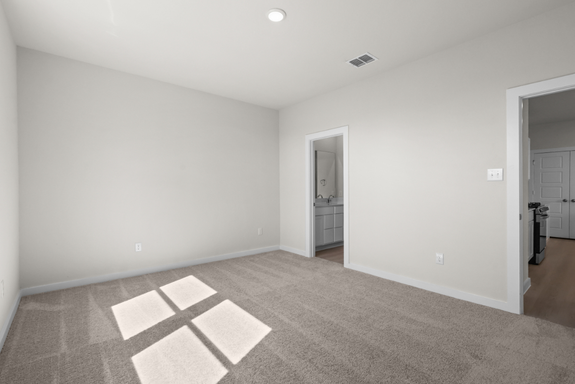 A room with a rug and a door.