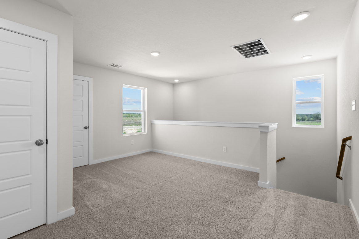 A room with white walls and a white bench.
