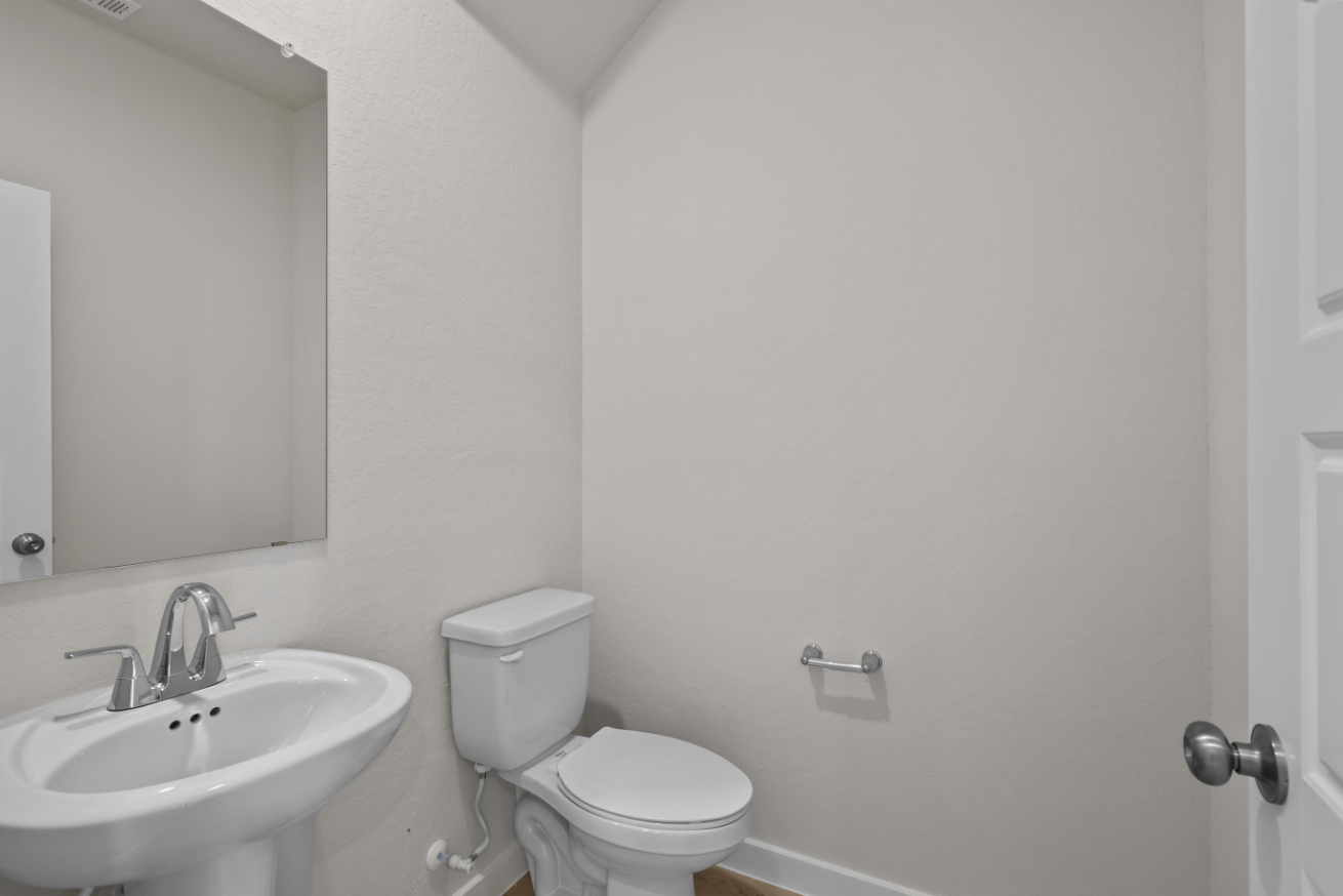 A bathroom with a toilet and sink.