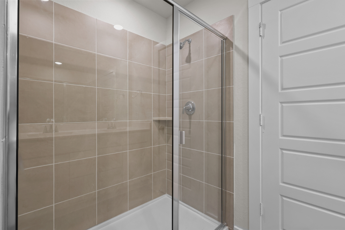 A shower with a glass door.