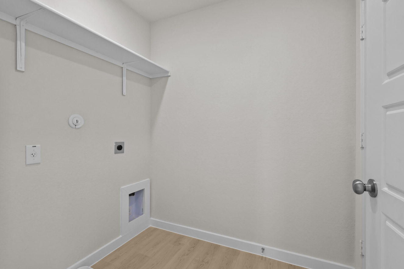 A white wall with a door and a white door.