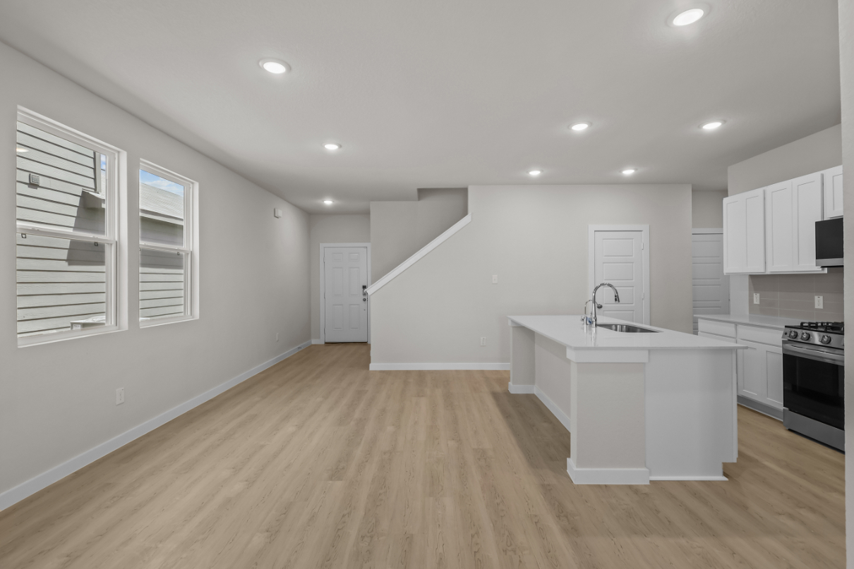 A kitchen with white cabinets.