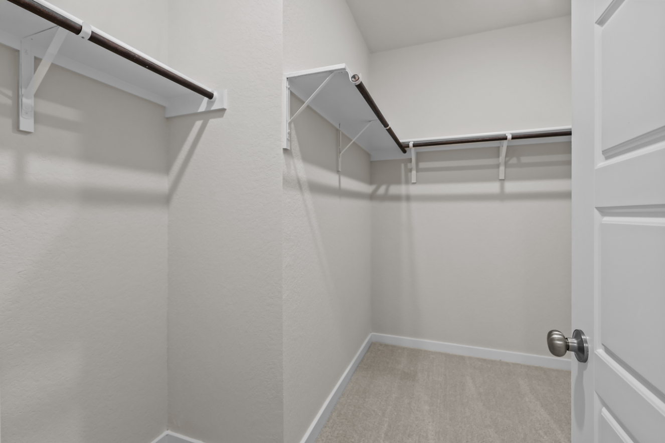 A white room with a metal railing.