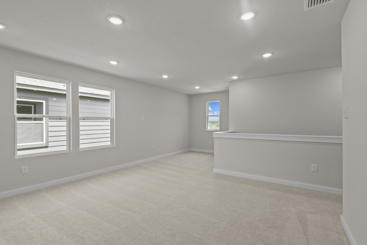 A room with a white wall and a window.
