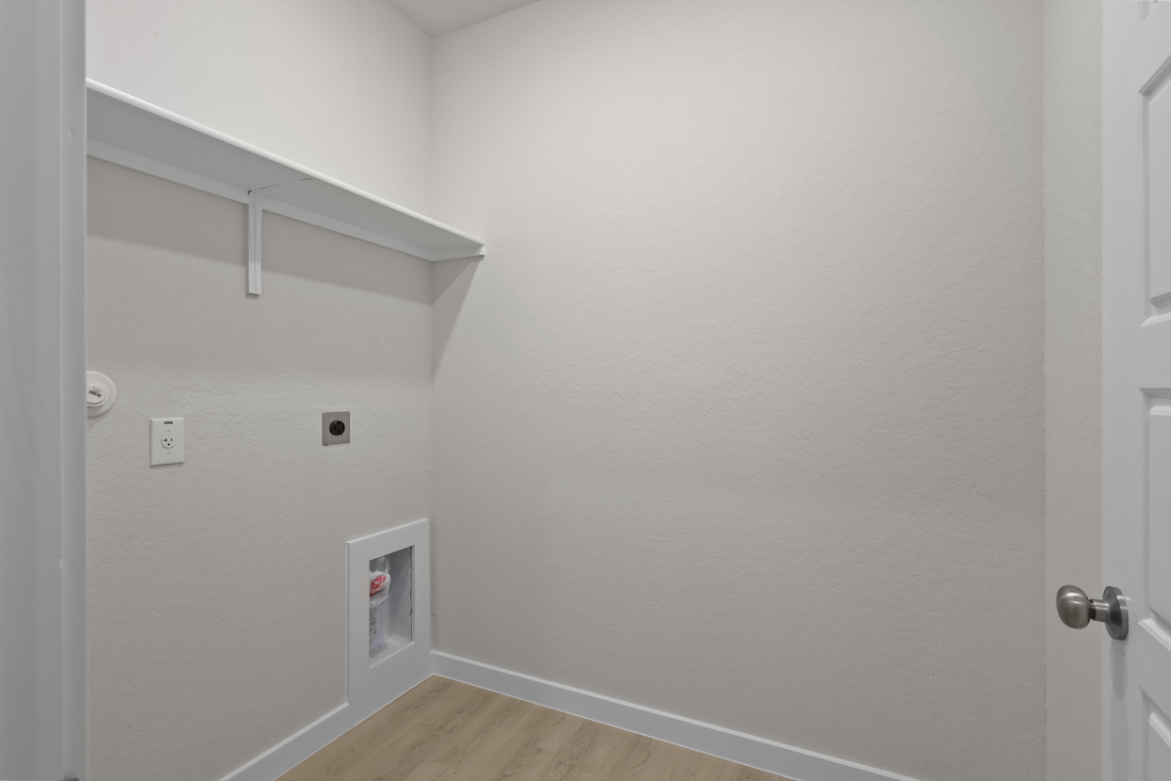 A white wall with a door and a white door.
