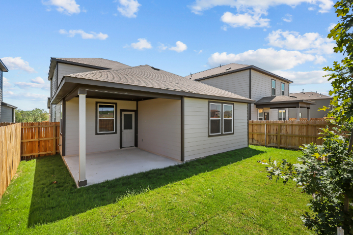 A house with a fence and grass.