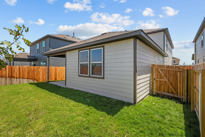 A house with a fence and grass.