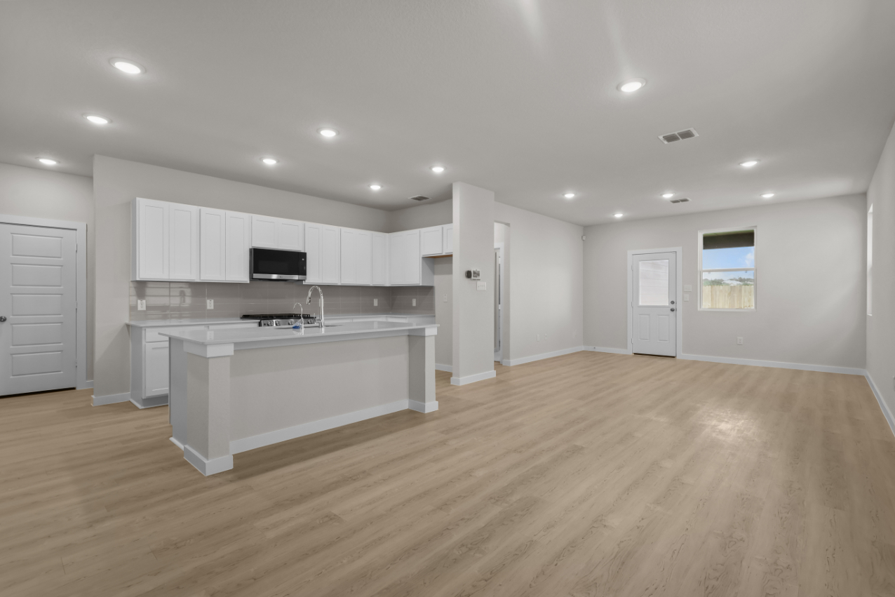 A kitchen with white cabinets.