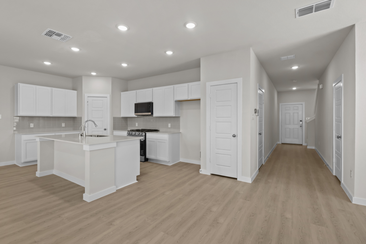 A kitchen with white cabinets.