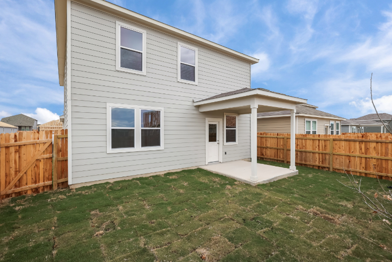 A house with a fence and grass.