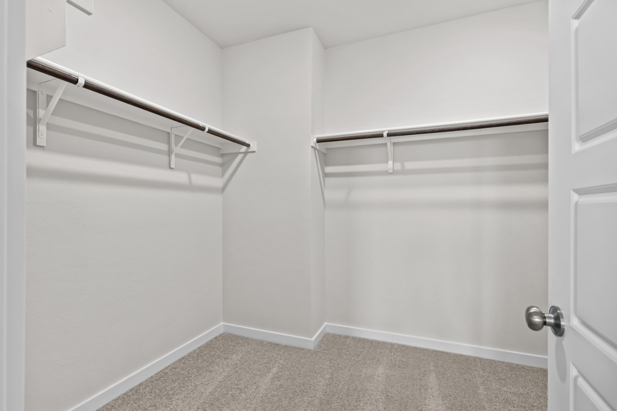 A white room with a metal bar.