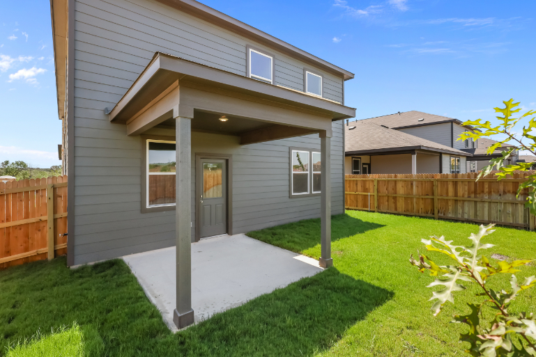 A house with a fence and grass.