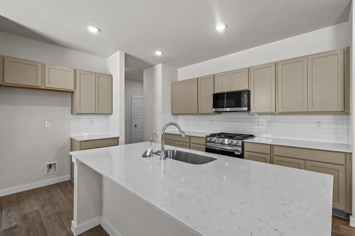 A kitchen with white cabinets.