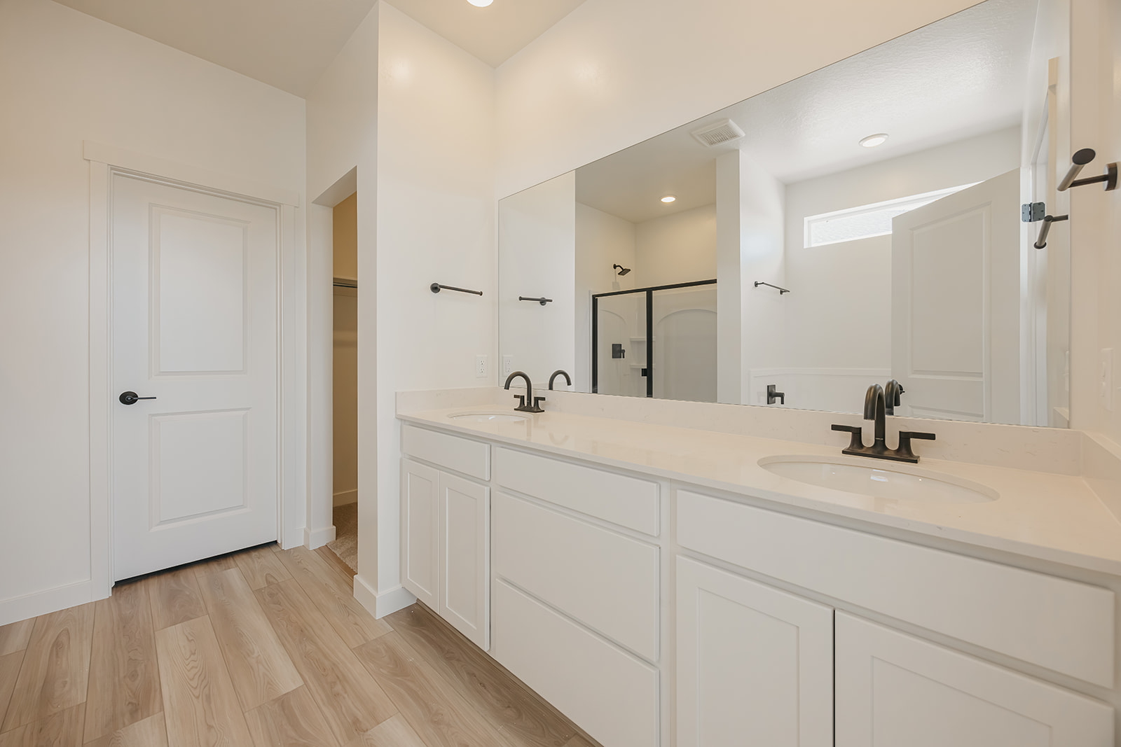 A bathroom with white cabinets.
