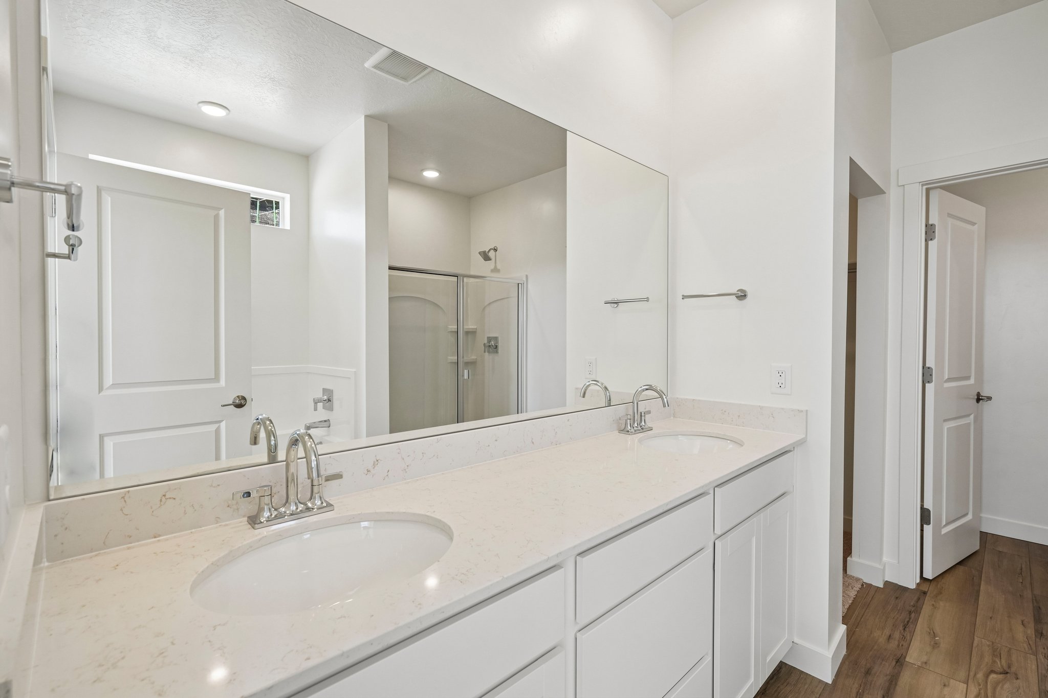 A bathroom with a large mirror.