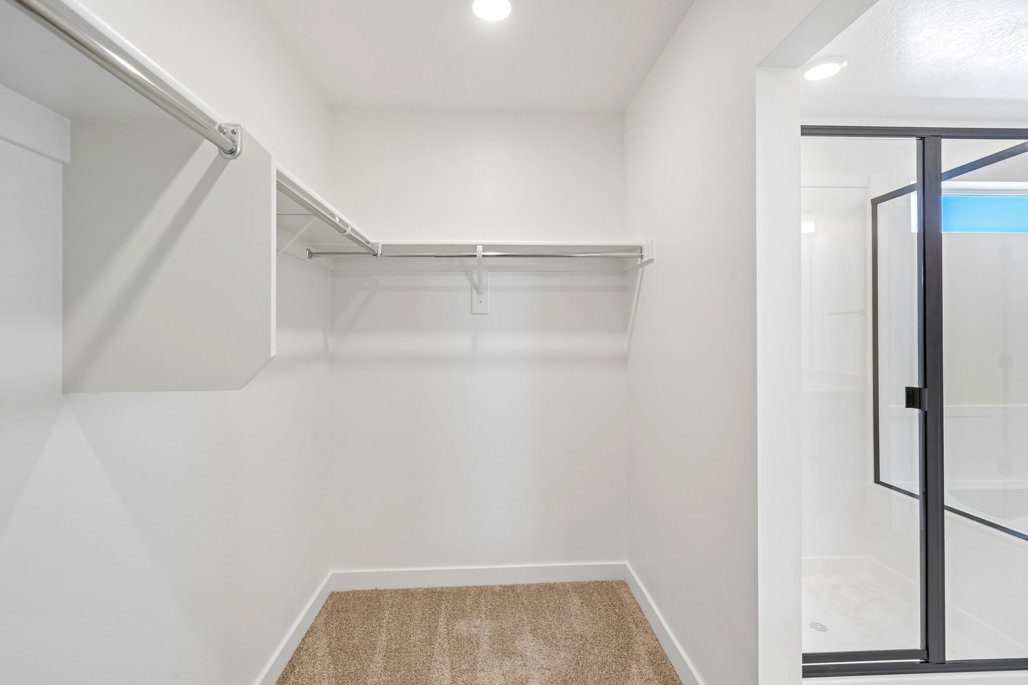 A white room with a glass door.