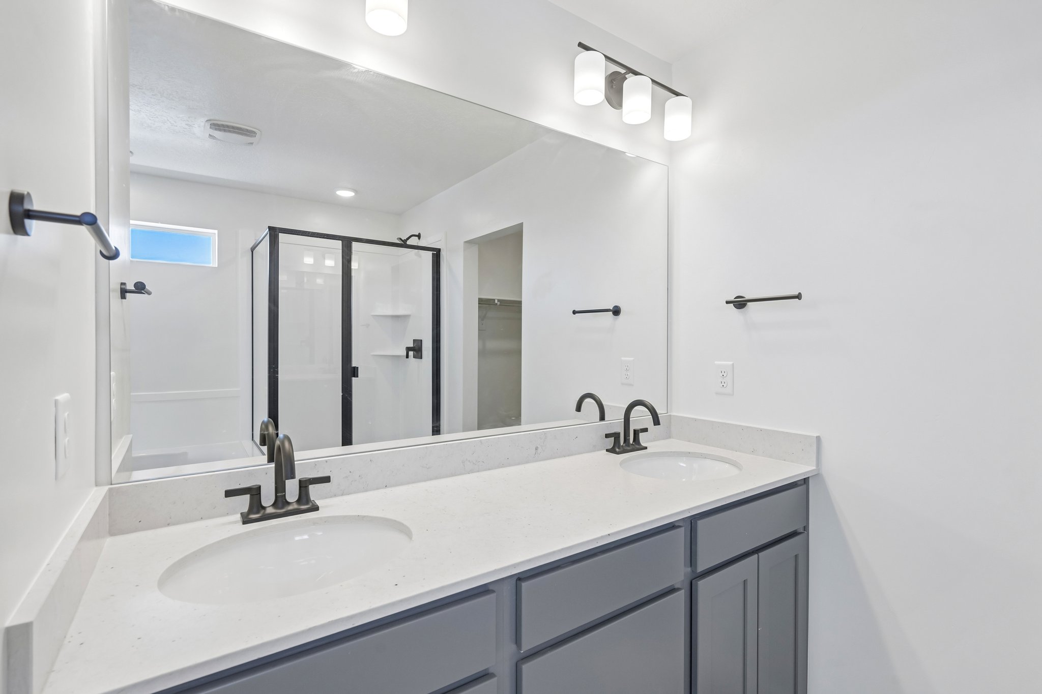 A bathroom with a large mirror.
