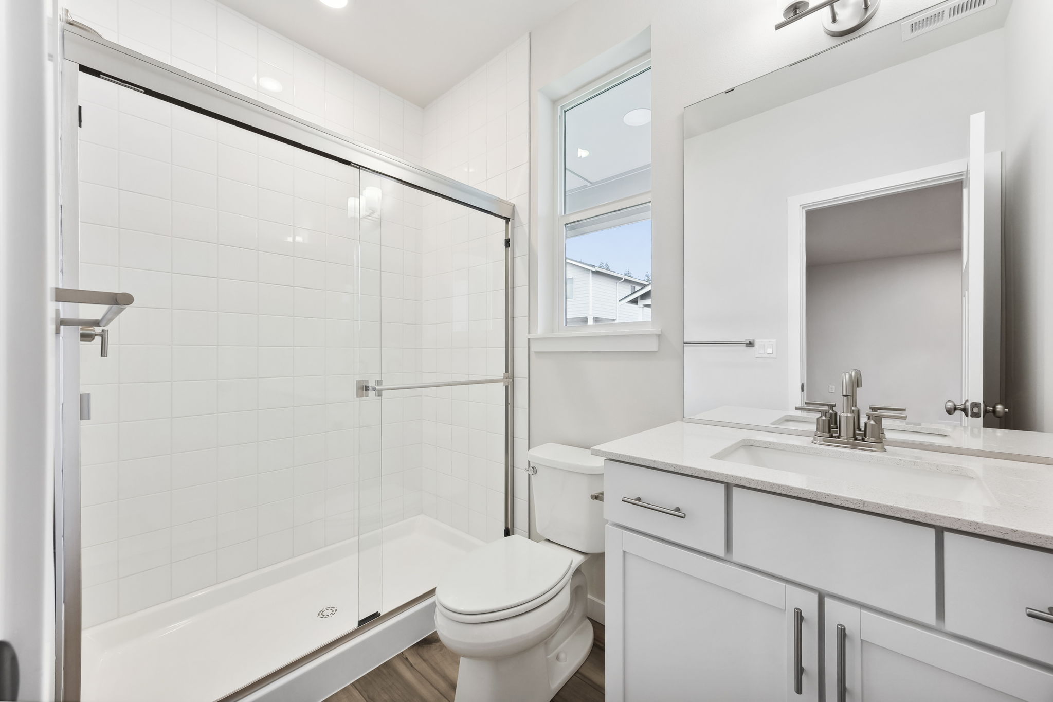 A bathroom with a shower and toilet.