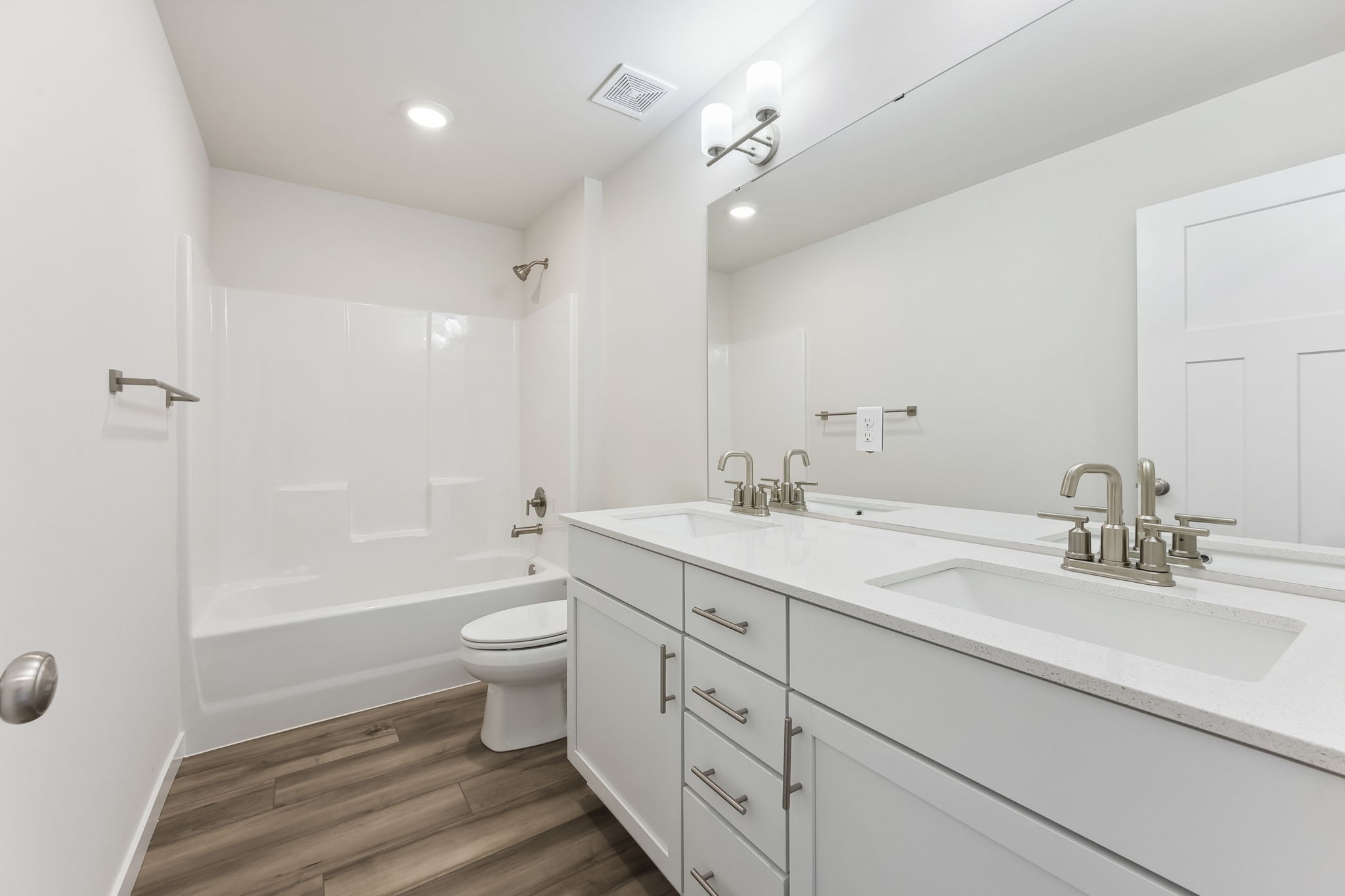 A bathroom with a tub sink and toilet.