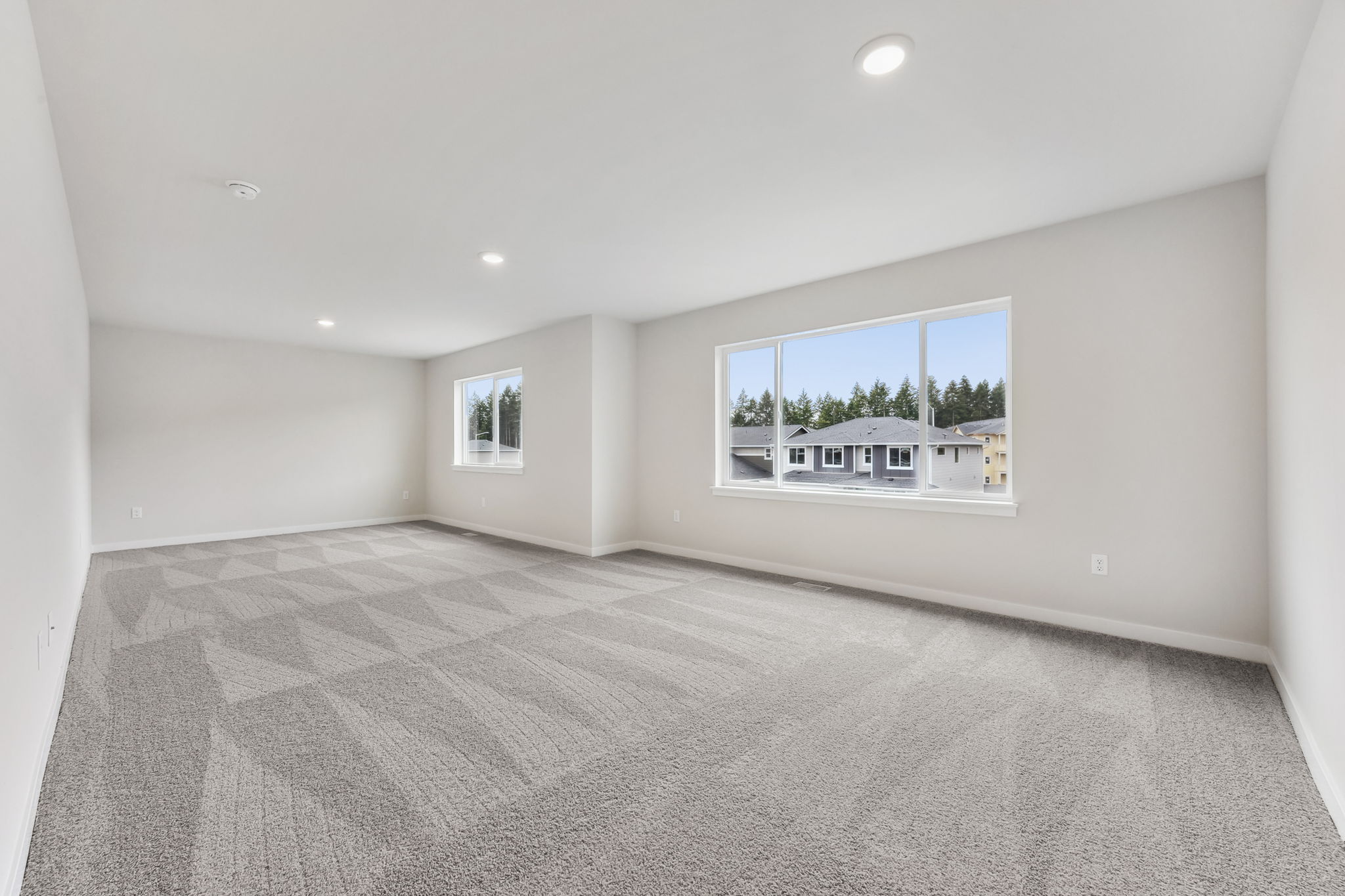A large empty room with a large window.