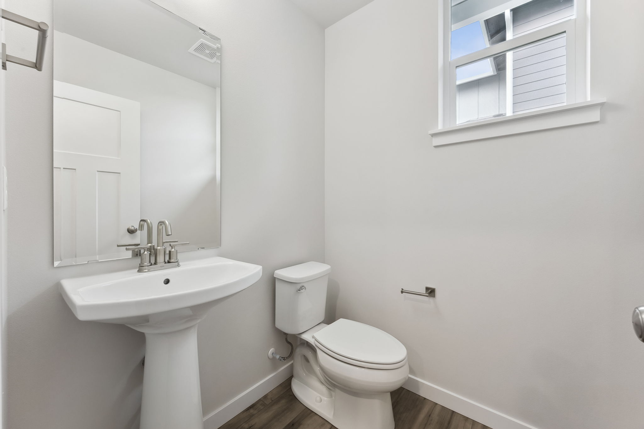 A bathroom with a toilet and sink.