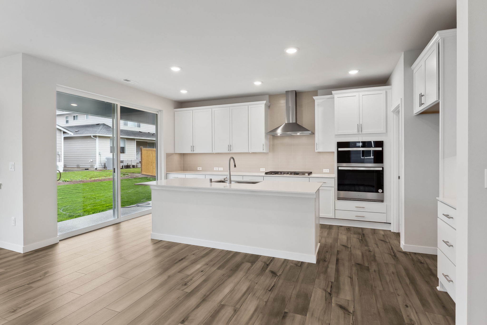 A kitchen with white cabinets.