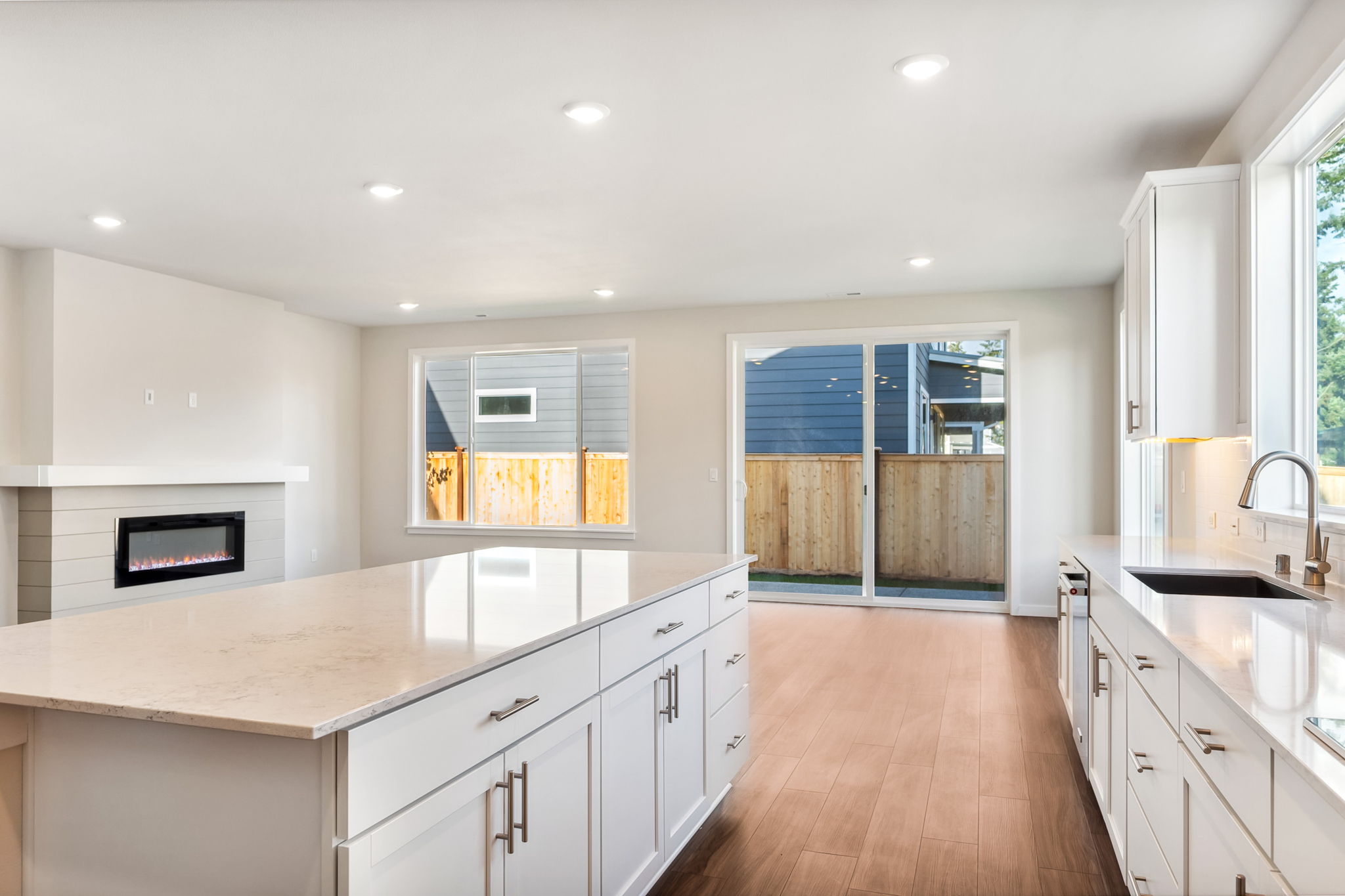 A kitchen with white cabinets.