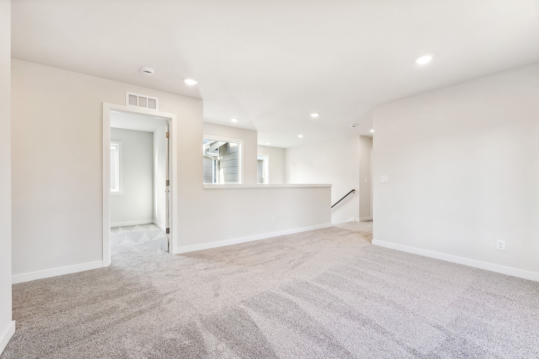 A room with a carpet and a door.