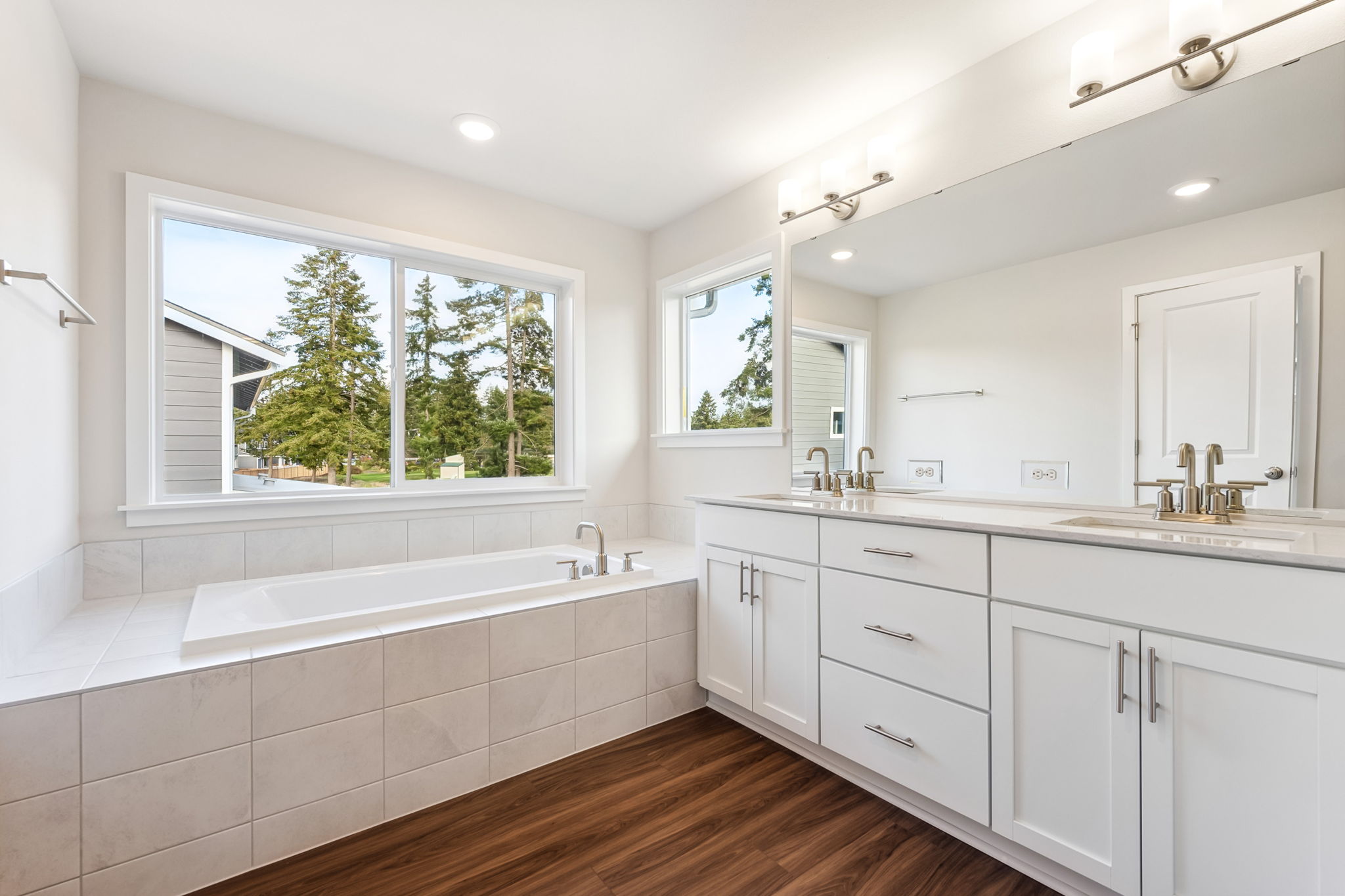 A bathroom with white cabinets.