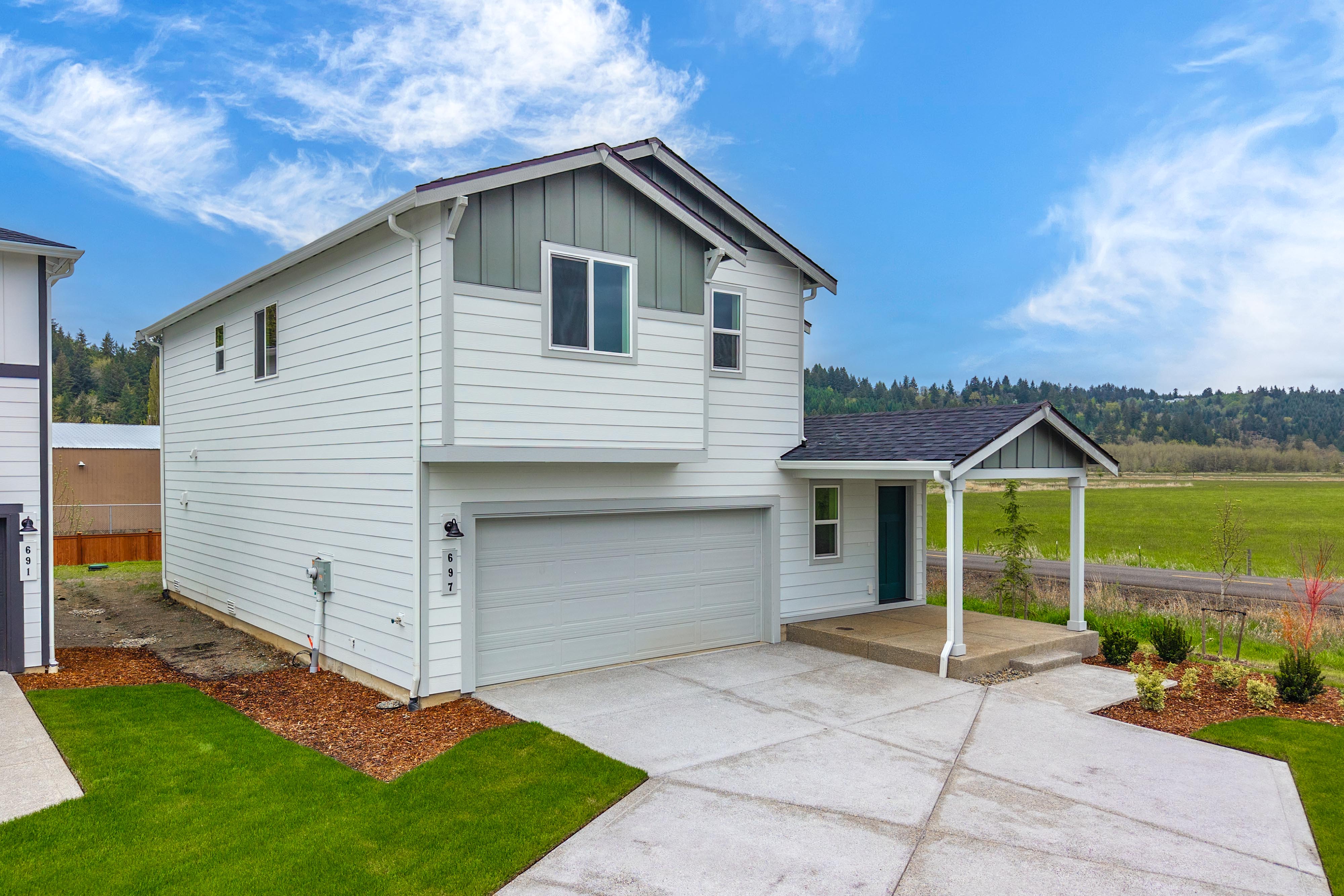 A white house with a driveway.