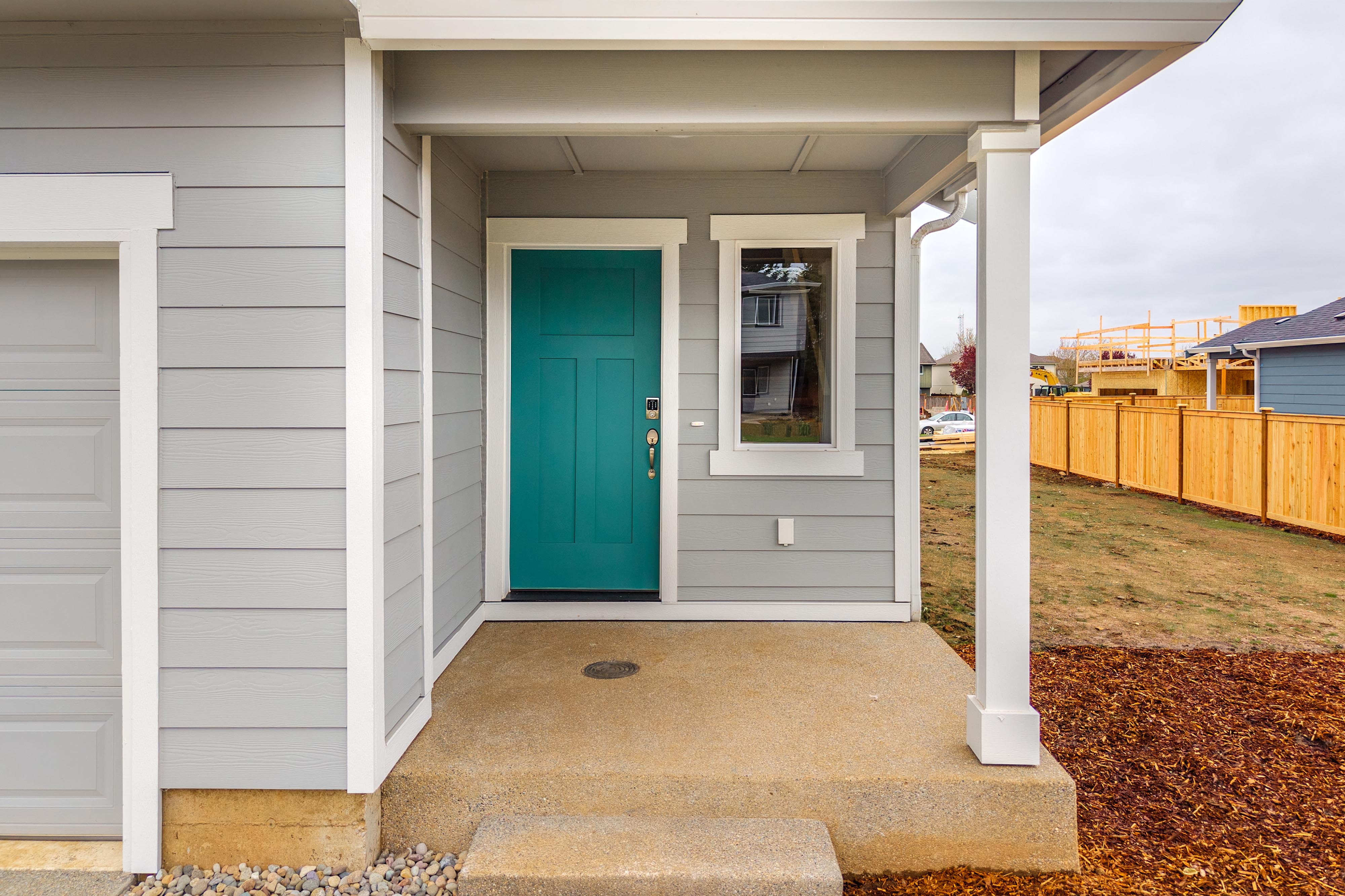A white house with a blue door.