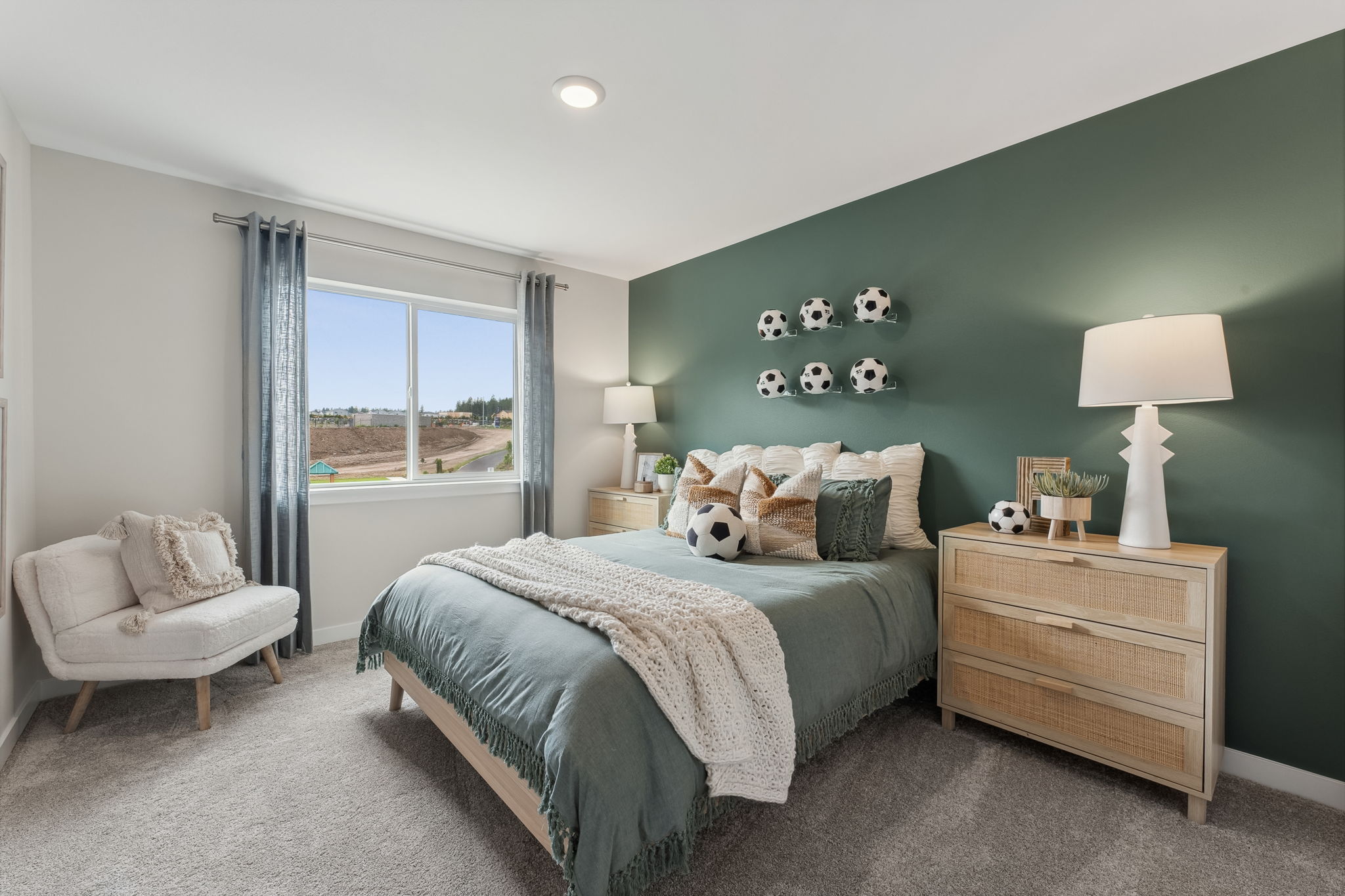 A bedroom with a bed and a chair.