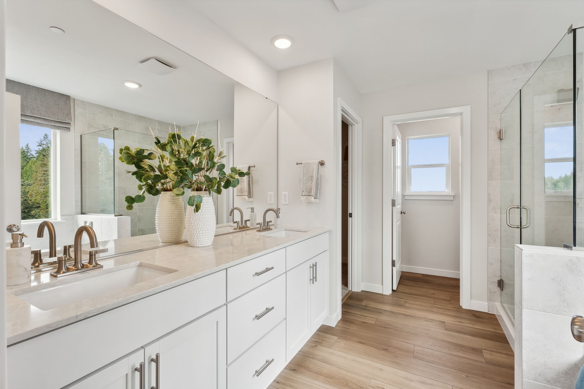 A bathroom with a large mirror.