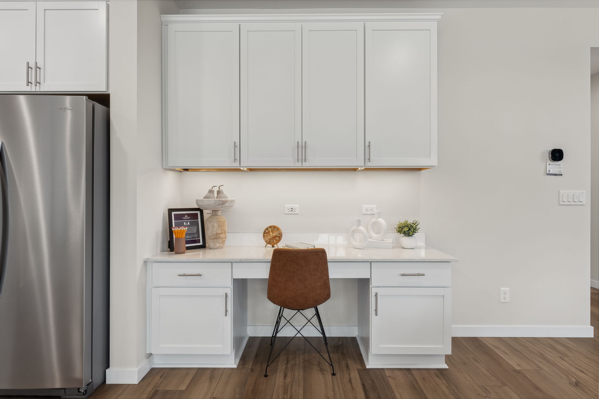 A kitchen with white cabinets.
