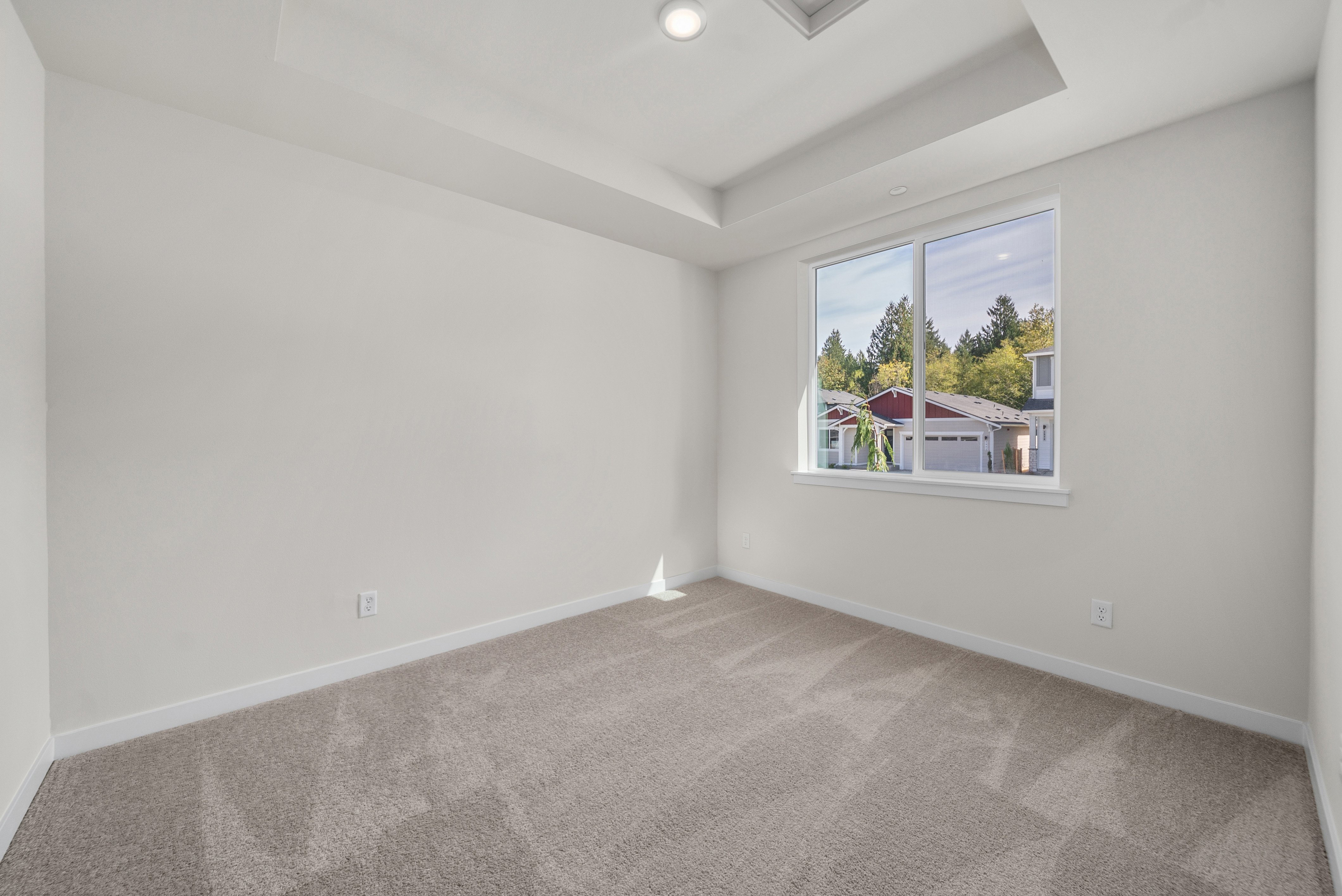 A room with a window and a carpet.