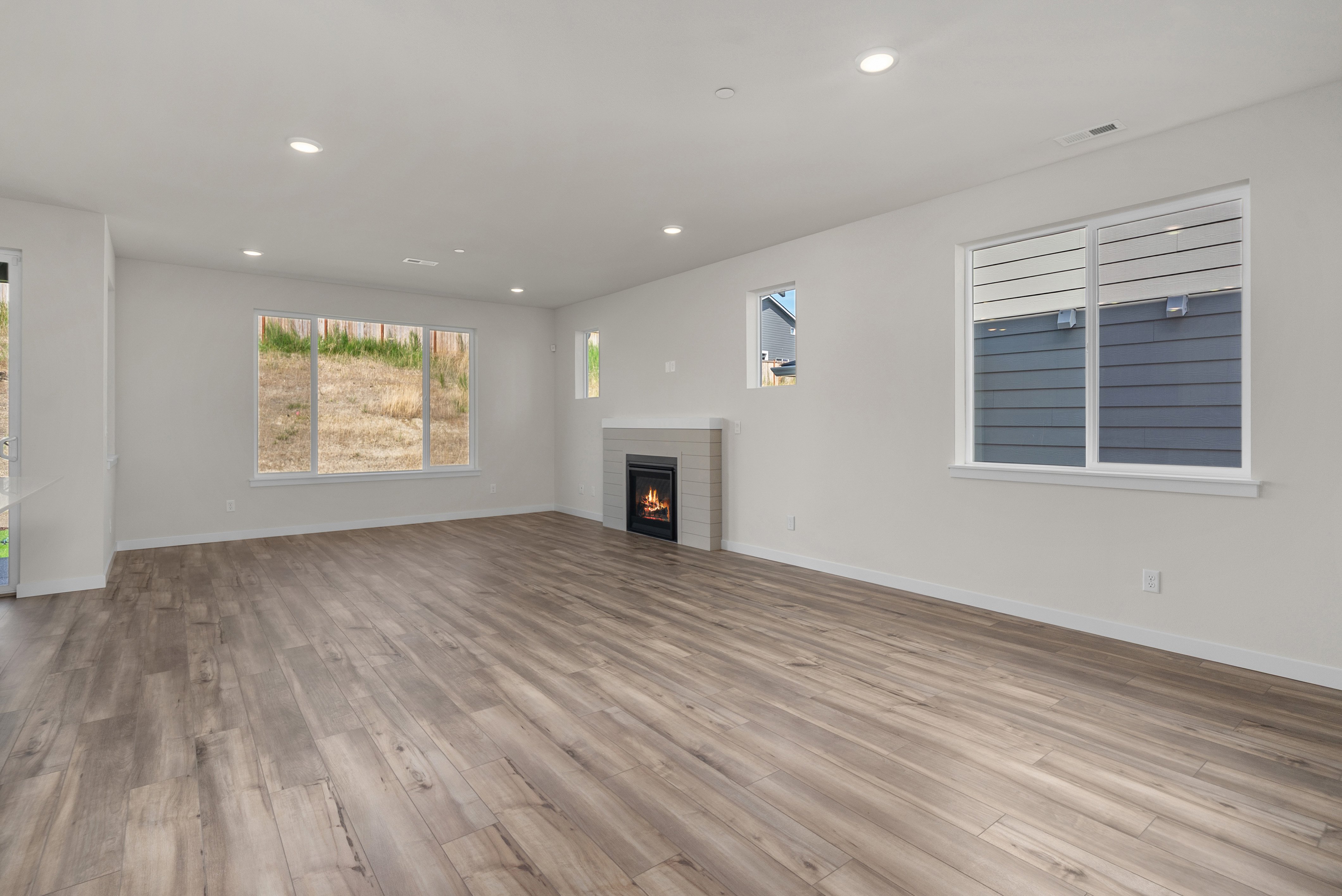 A room with a fireplace and a wood floor.
