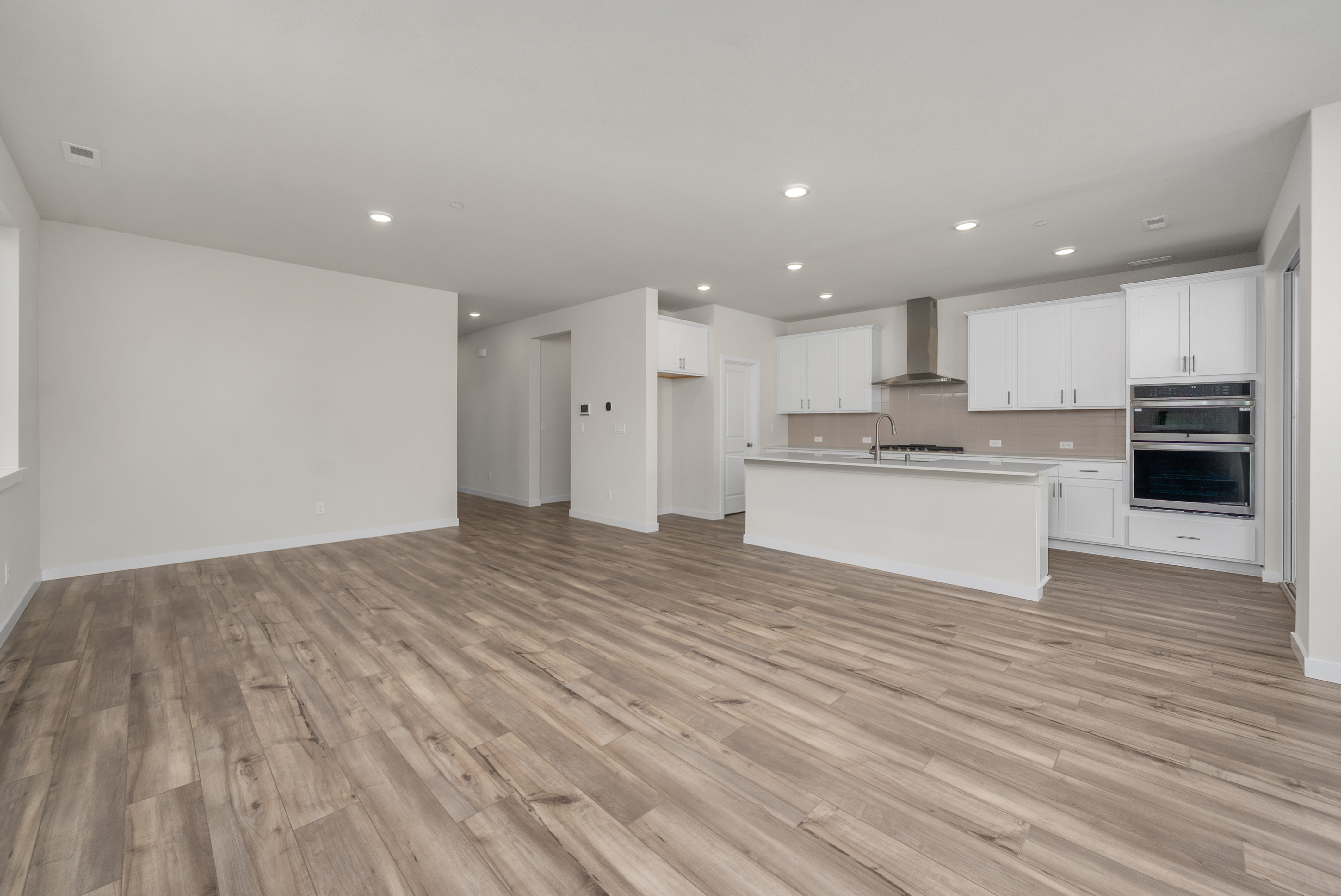 A large kitchen with white cabinets.