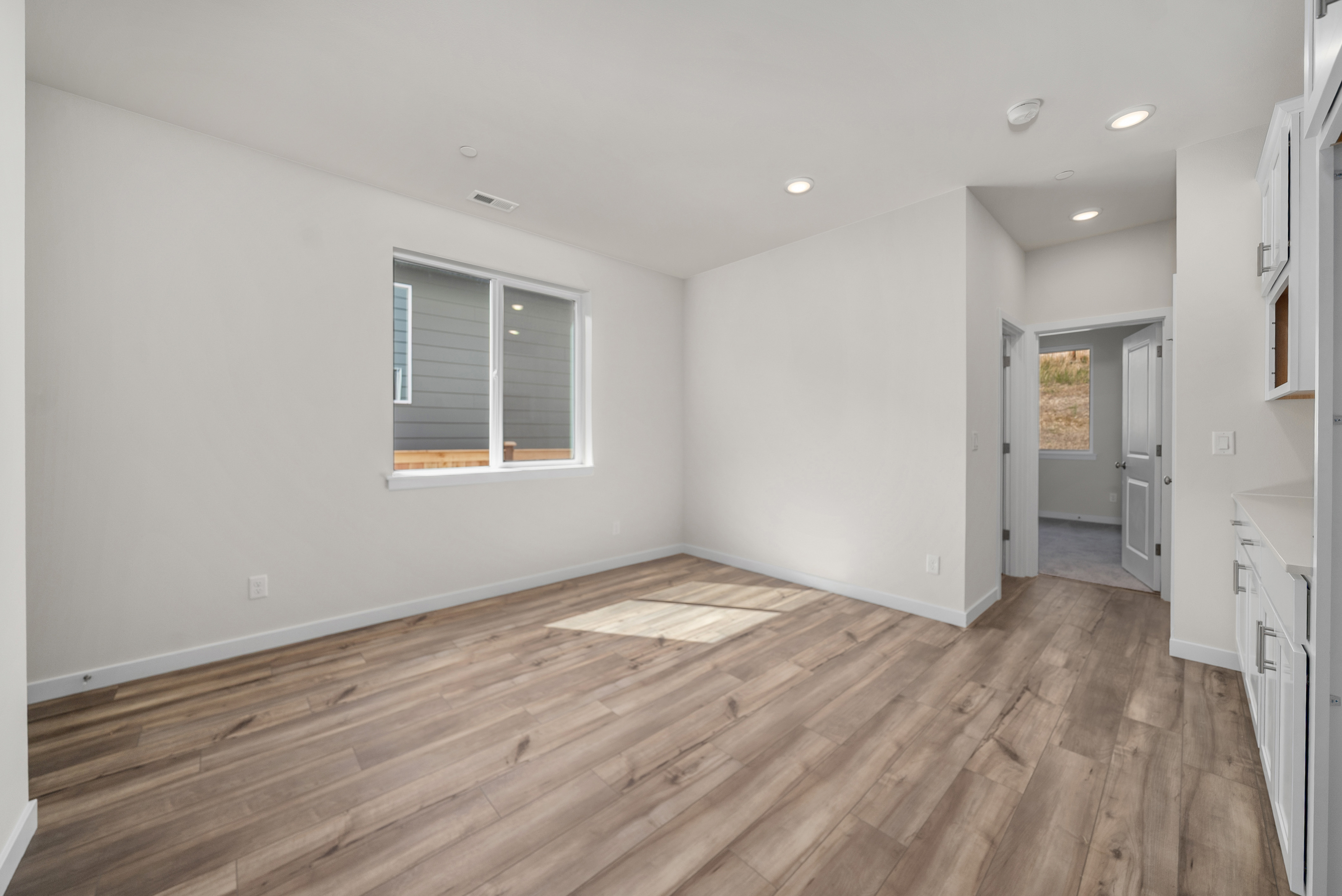 A room with a wood floor and a wood floor.