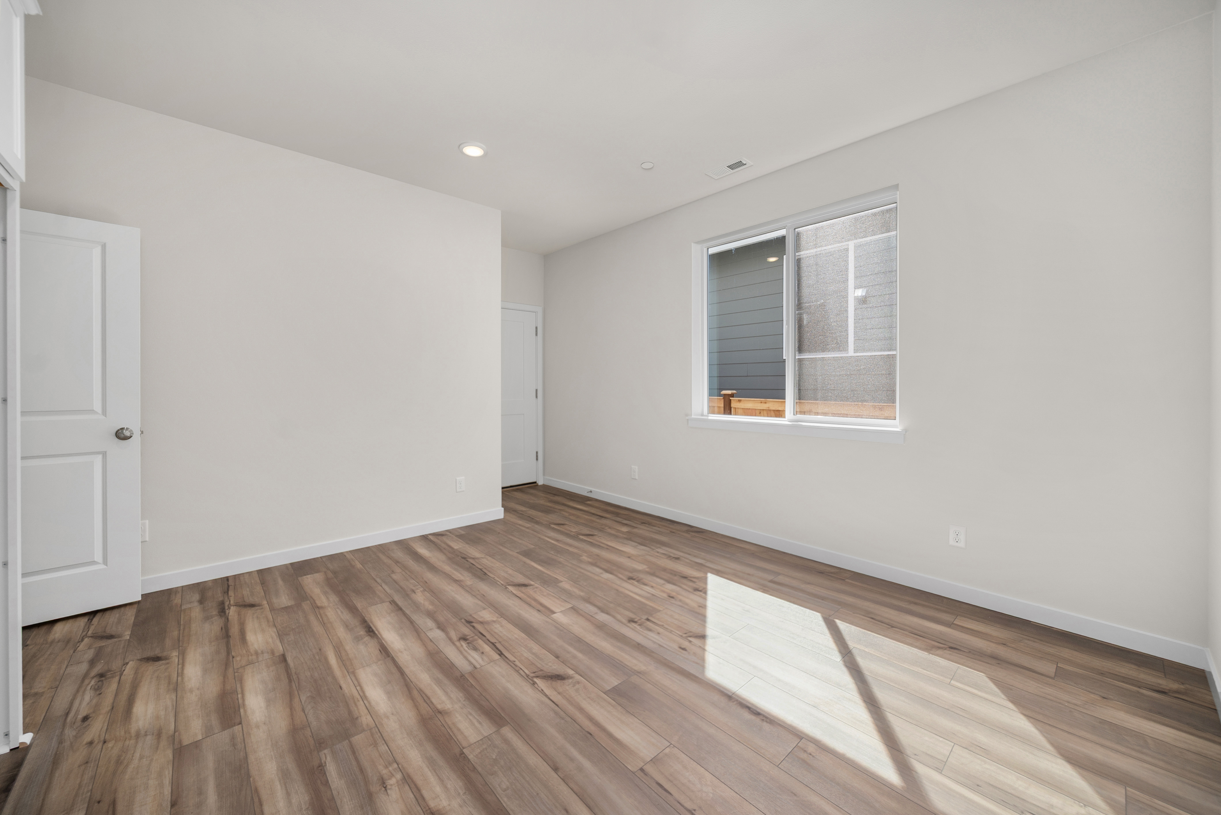 A room with a wood floor and a wood floor.