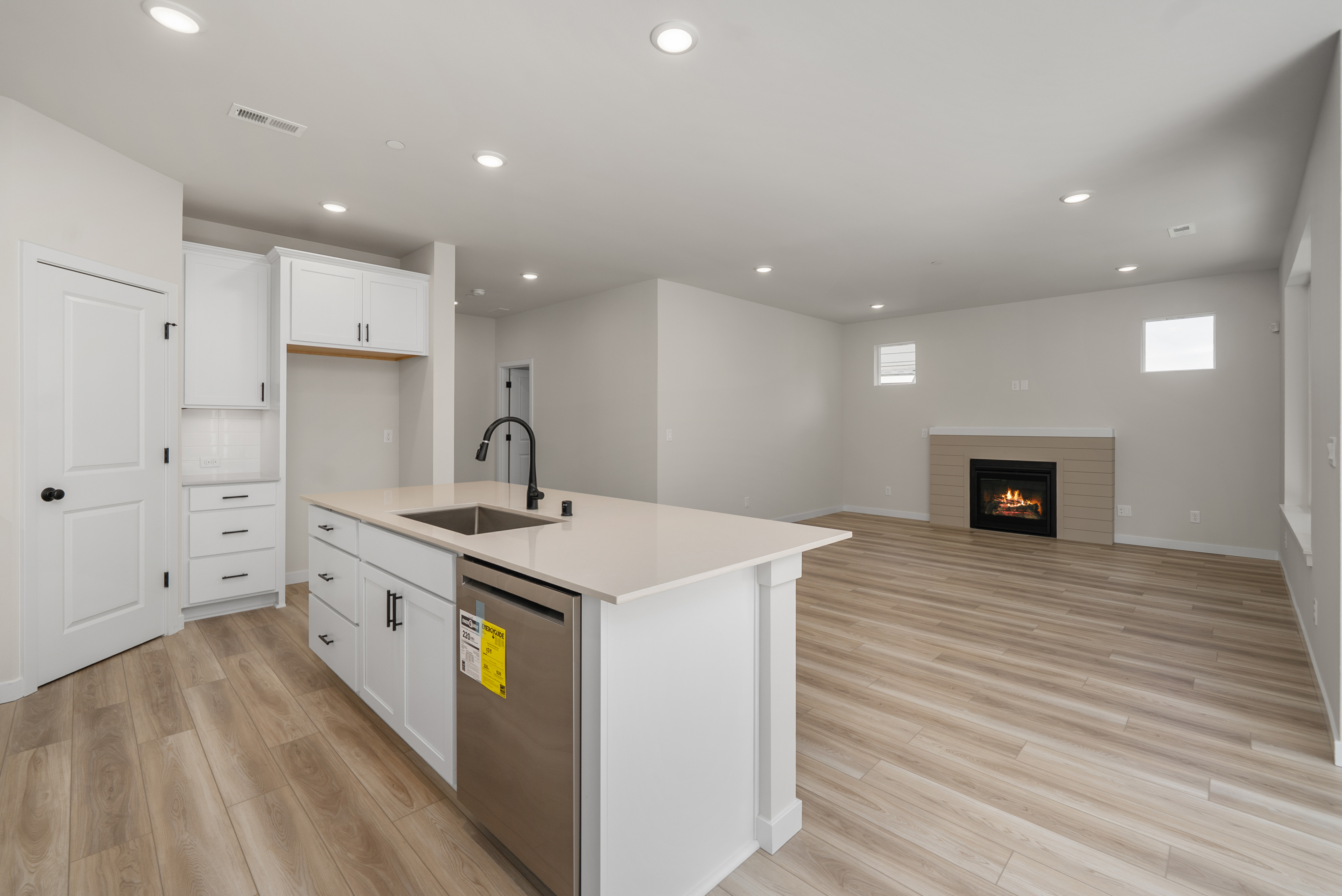 A kitchen with white cabinets.