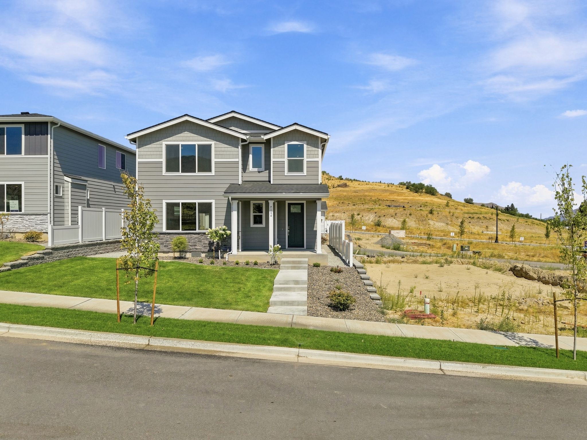 A house with a hill in the background.