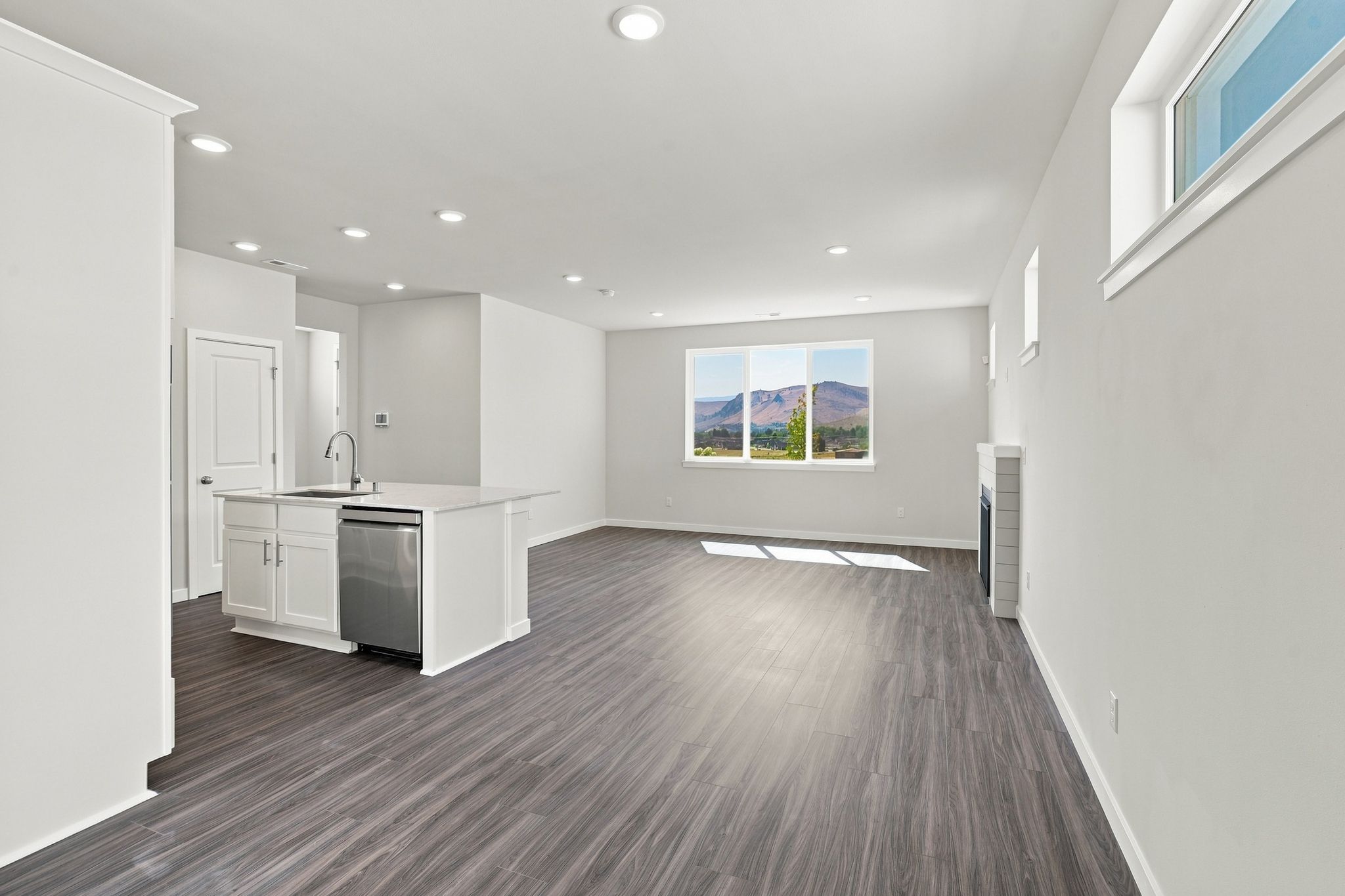 A large empty room with white cabinets.