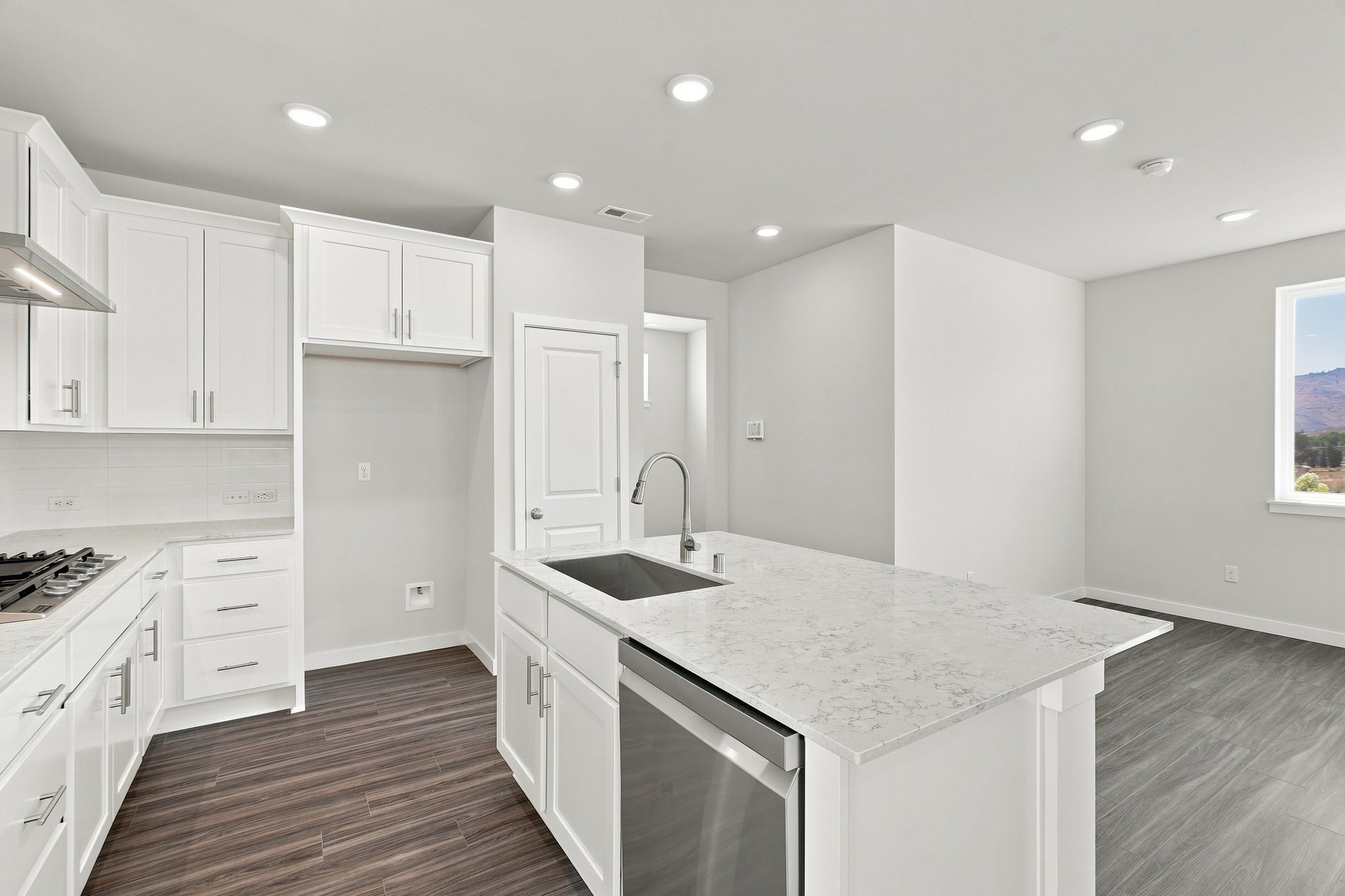 A kitchen with white cabinets.